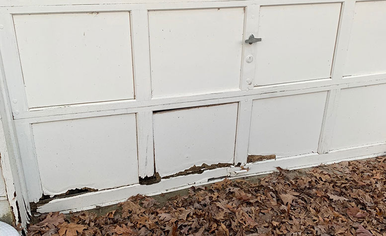 water damaged garage door panel 